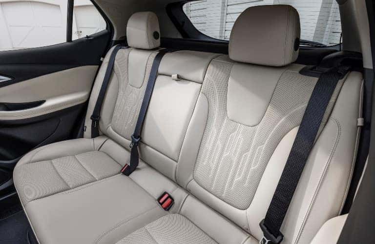 Diagonal Backseat View of 2024 Buick Encore GX Avenir with Whisper Beige and Jet Black interior