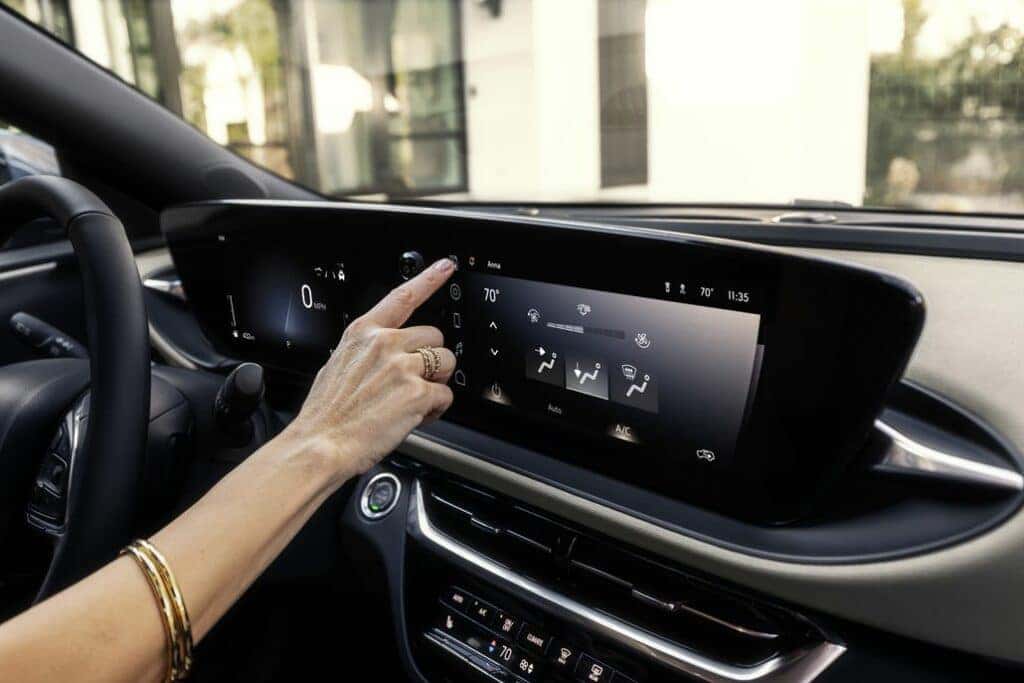 Driver interacting with the new Ultrawide Infotainment Display in the 2024 Buick Envista Avenir.