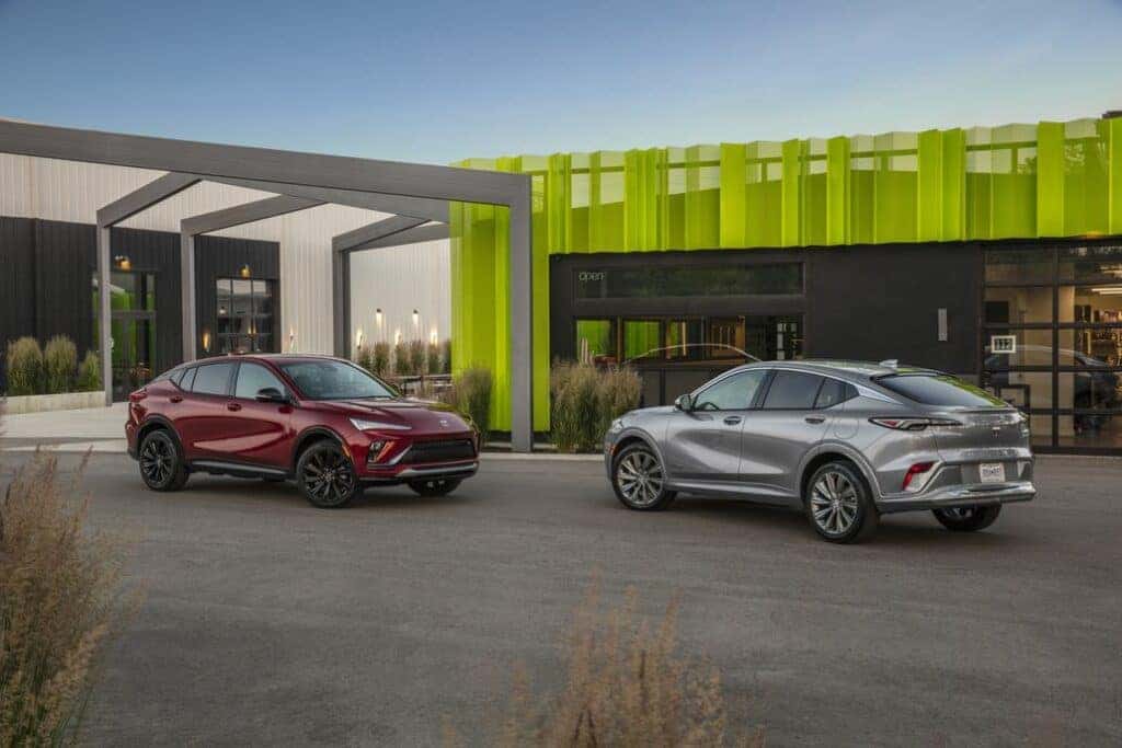 Two Buick Envistas Parked in Front of a Mansion