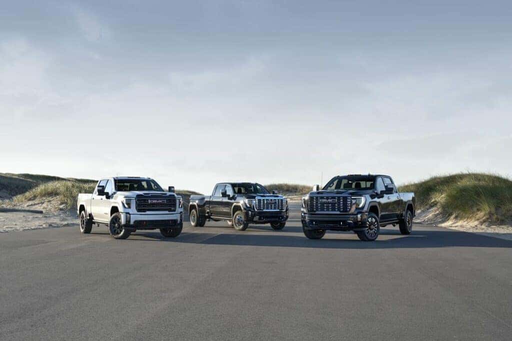 Three GMC Sierra 2500 HDs Parked on a Beach Parking Lot