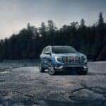 The Glamorous GMC Acadia Denali On The Edge Of A Sparse Forest