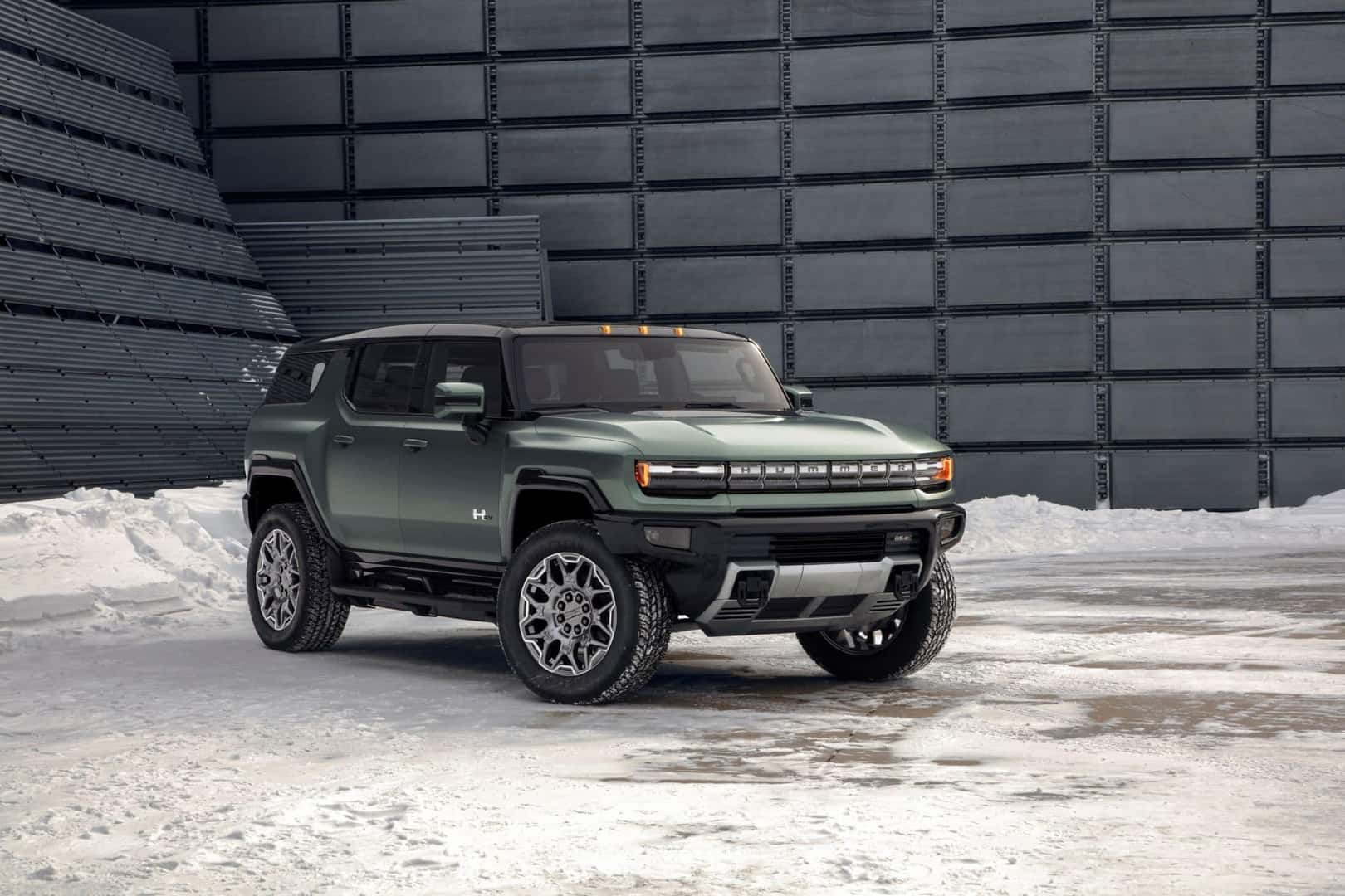 Green 2024 GMC Hummer EV front and passenger side view