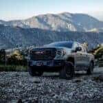 The Powerful 2024 GMC Sierra AT4X AEV Trekking Up A Rocky Hill