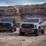 Two Magnificent 2025 GMC Yukon Denali Ultimates On Rocky Desert Terrain