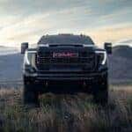 The Fascinating Front End Of The Fantastic 2026 GMC Sierra 2500, Parked On A Hill With Massive Mountains In The Background