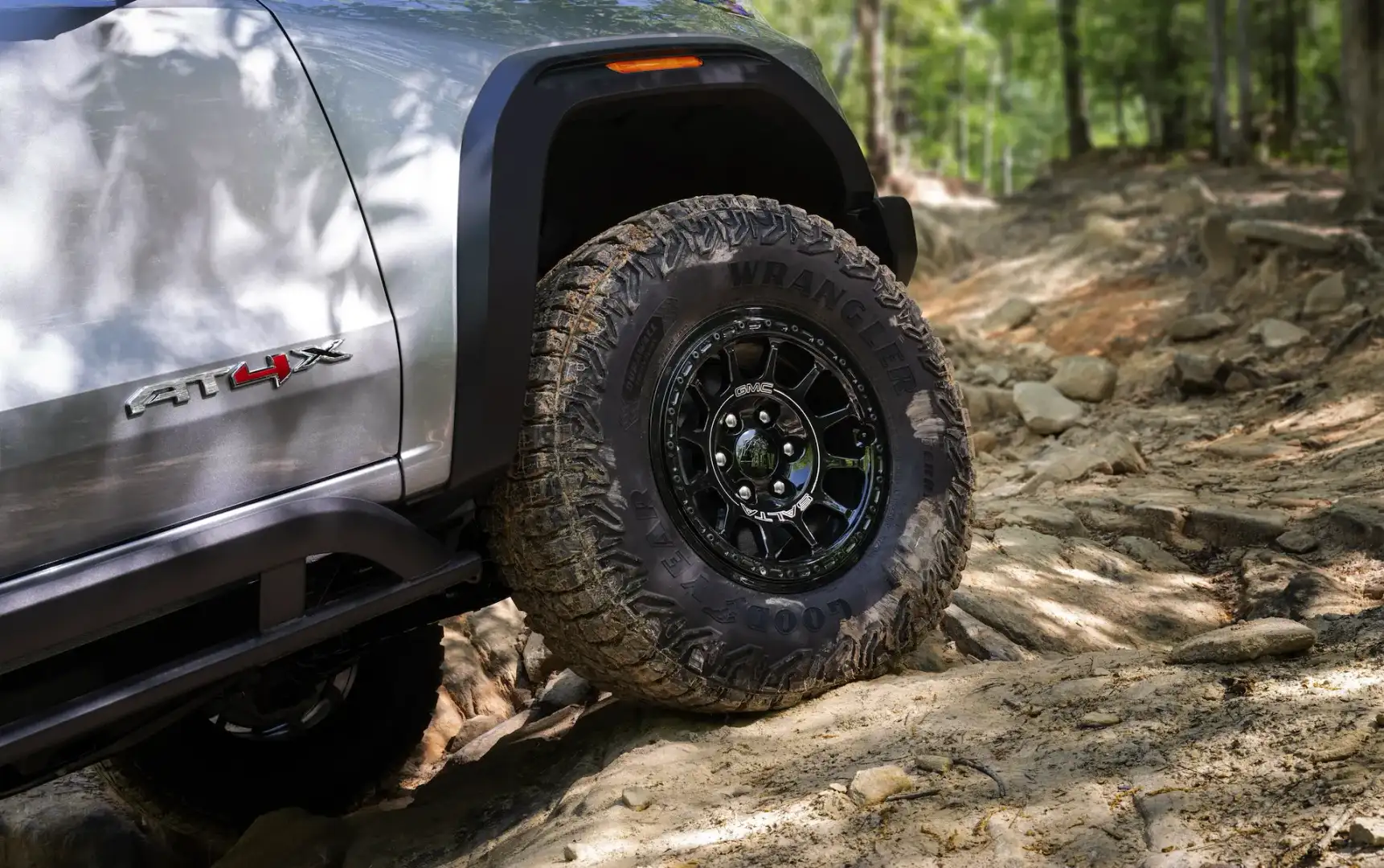 Wheel and Tire from GMC Canyon off roading on boulders 
