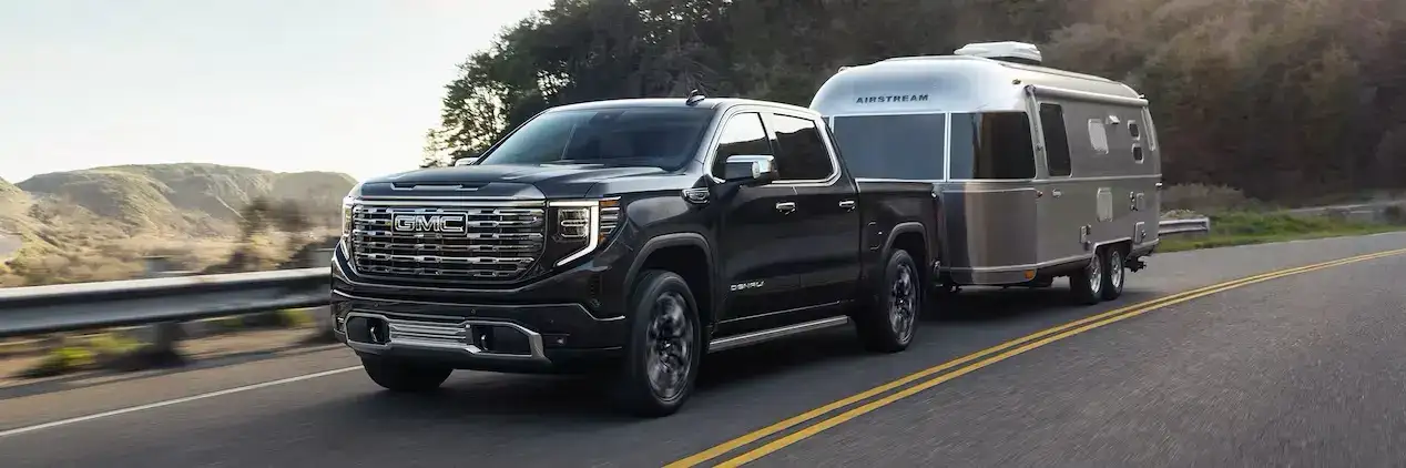 Black GMC Sierra 1500 Denali towing an airstream