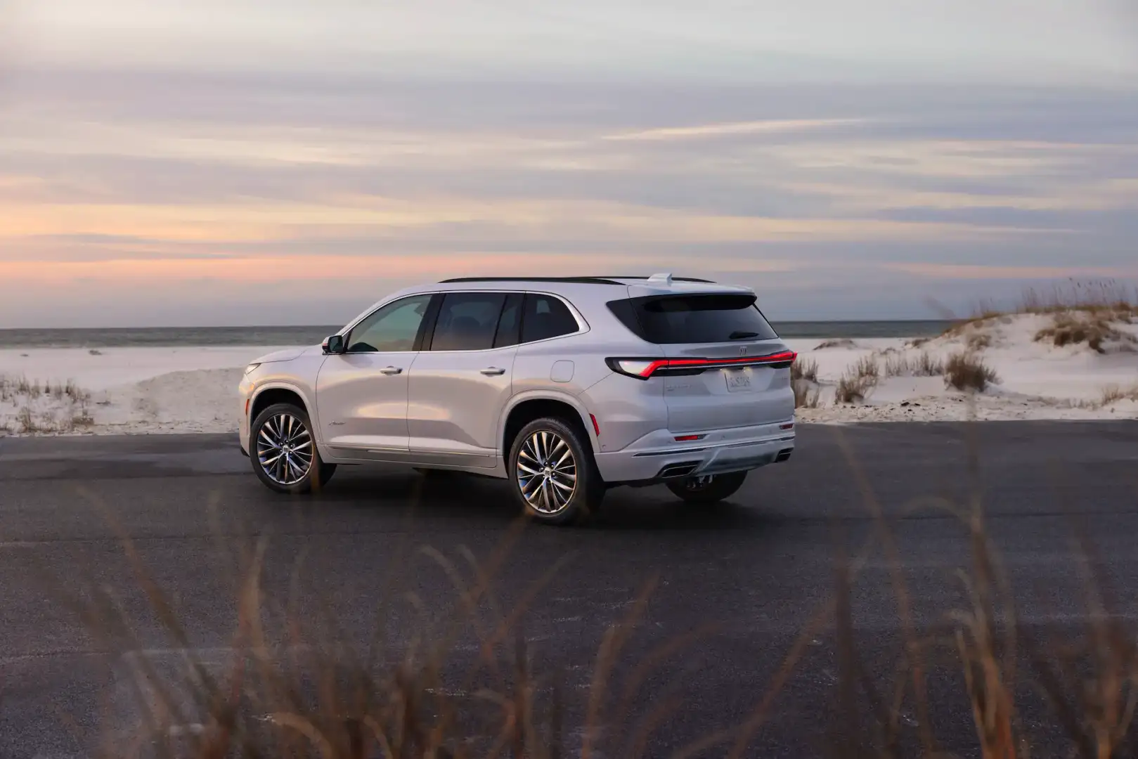 White Buick Enclave Avenir rear view parked at the beach