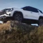 White 2026 GMC Terrain AT4 off roading on the top of a mountain