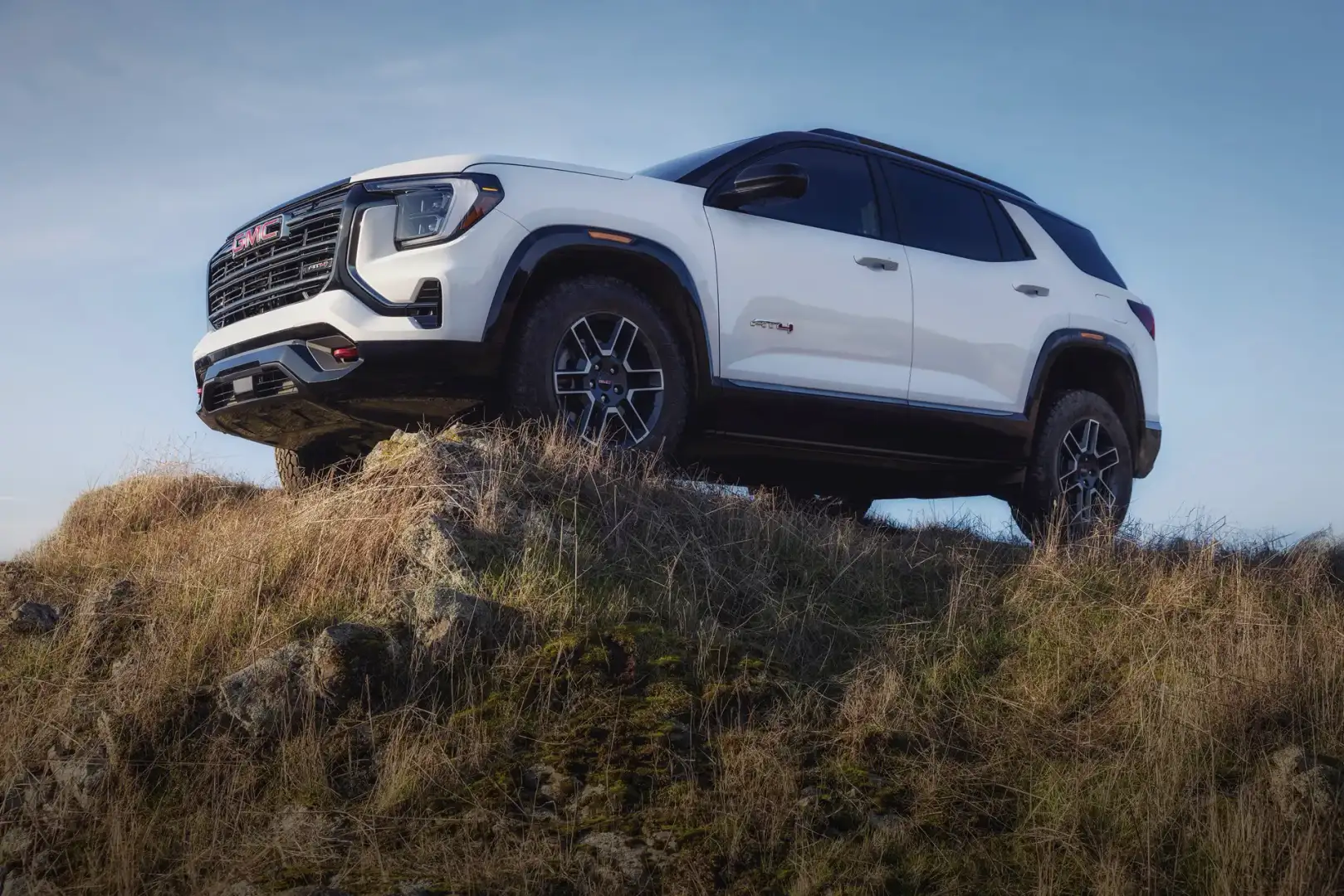White 2026 GMC Terrain AT4 off roading on the top of a mountain