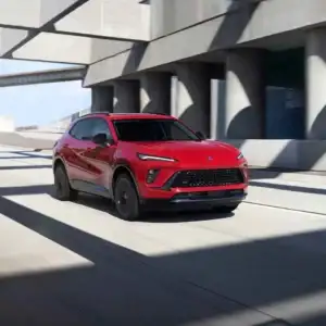 2026 Buick Envision Brilliant Red driving on a highway
