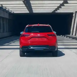 2026 Buick Envision Brilliant Red rear view in motion