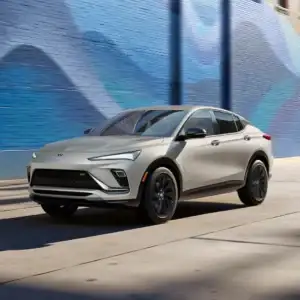 2026 Buick Envista Ceramic driving past brick building