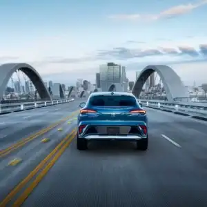 2026 Buick Envista Ocean Blue Metallic driving on a bridge