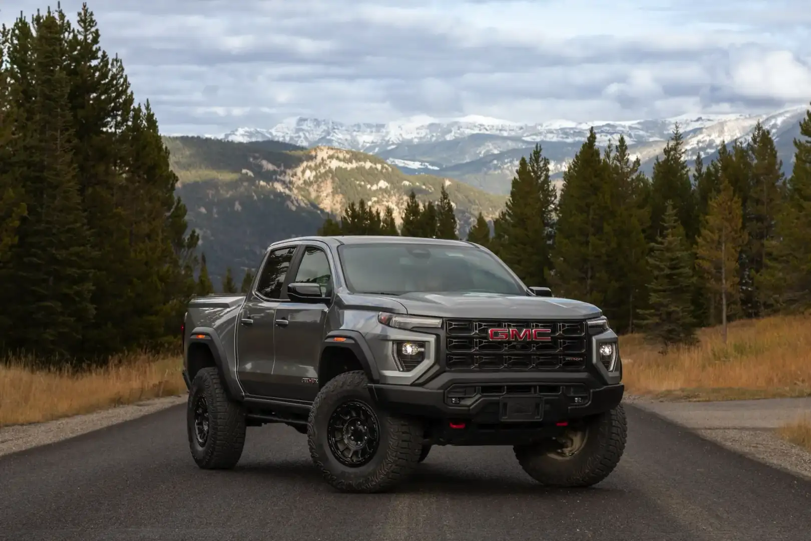 GMC Canyon AT4X edition parked on the road in front of mountains and trees