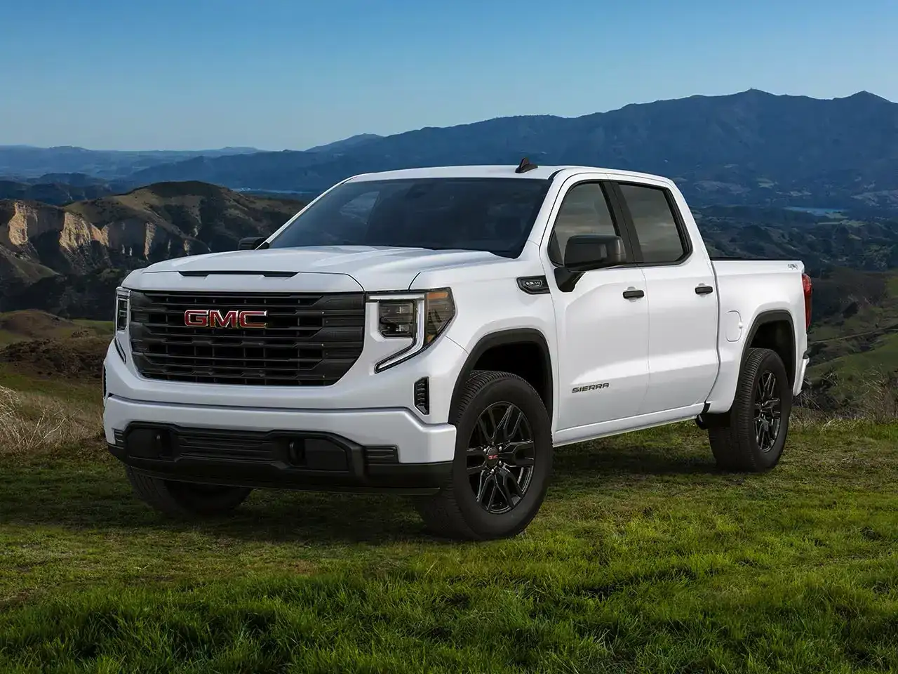 2026 GMC Sierra Pro in White Frost Tricoat parked off road in front of mountains