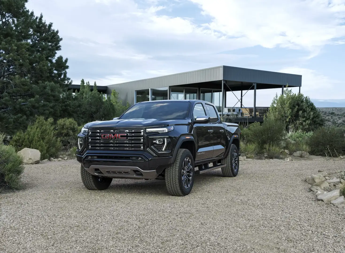 GMC Canyon Denali parked by a house