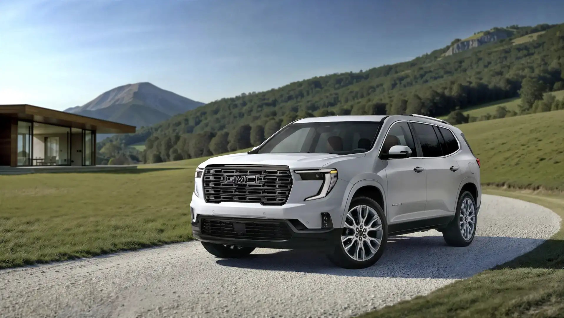 2026 GMC Acadia Denali Ultimate driving on a gravel road