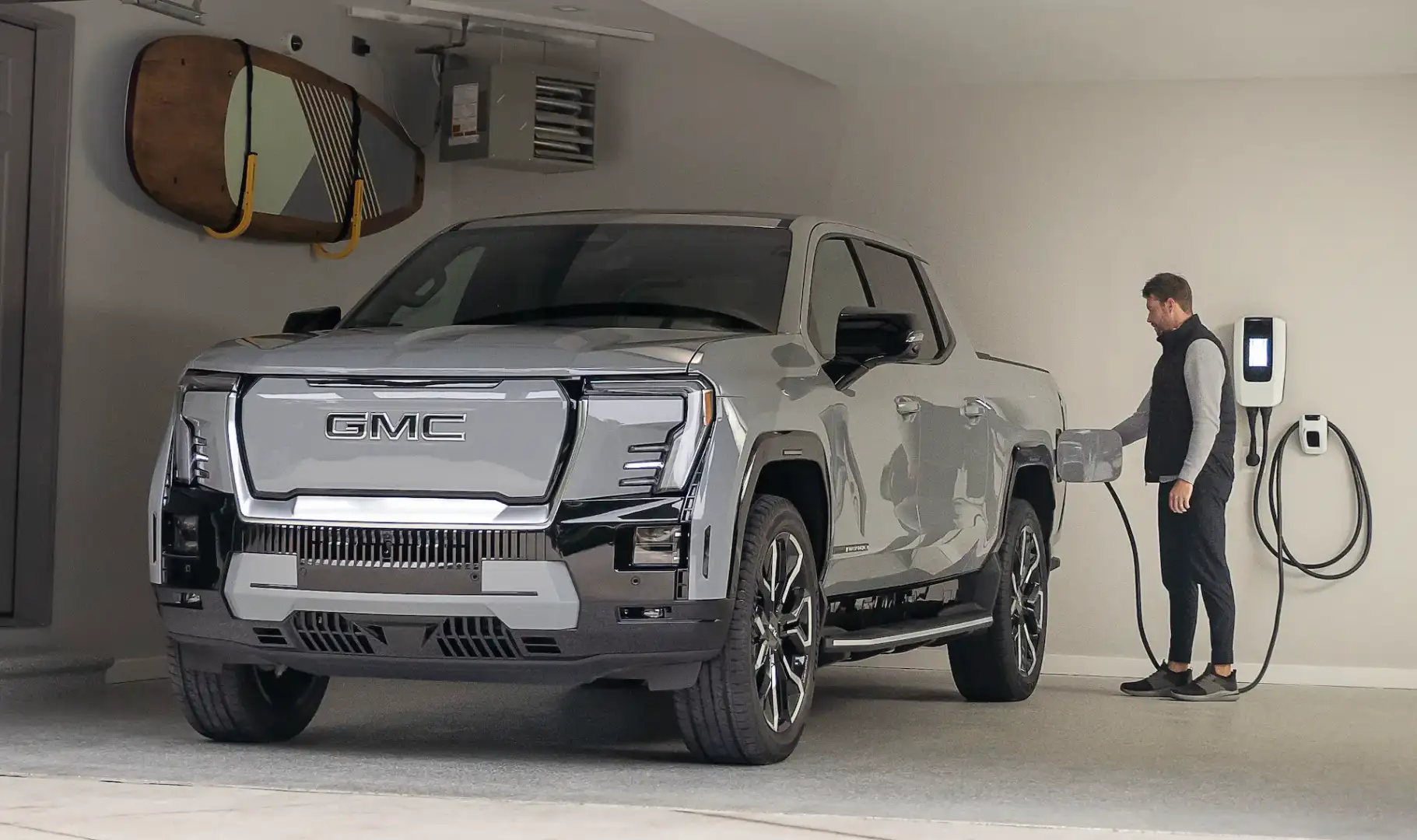 GMC Sierra EV Denali charging in a garage