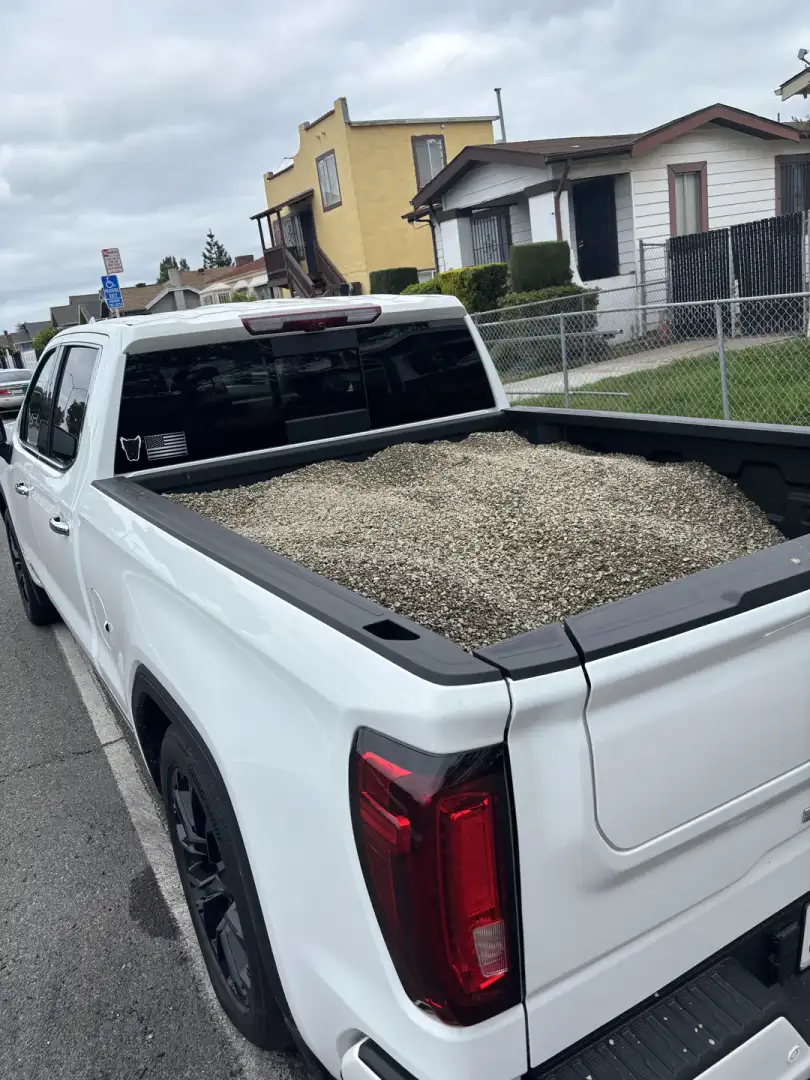 GMC Sierra Denali carrying gravel in the bed