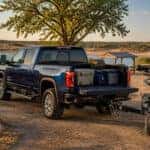 2026 GMC Sierra 2500 HD hitched to a trailer at a North Texas lake campground, ready for a fall weekend getaway