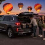 2026 Buick Enclave loaded with festival gear at Oak Point Park in Plano TX with hot air balloons glowing at dusk