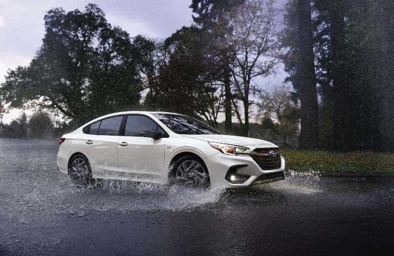 White 2023 Subaru Legacy Driving in Rain