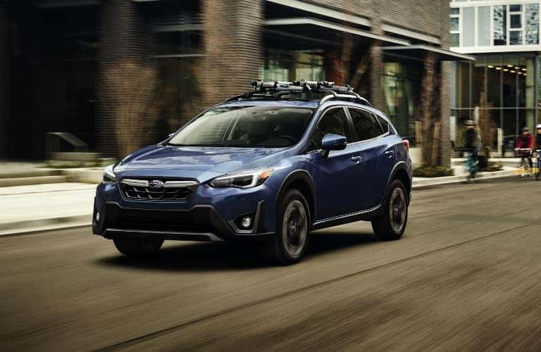 Blue 2023 Subaru Crosstrek Driving on City Street