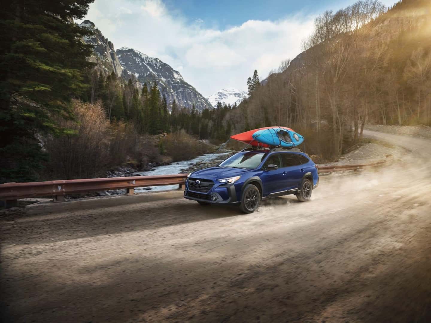 The 2023 Subaru Outback, With A Boat Hitched On The Top, Driving Towards An Active Adventure