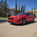 2026 Subaru Impreza Pure Red in motion