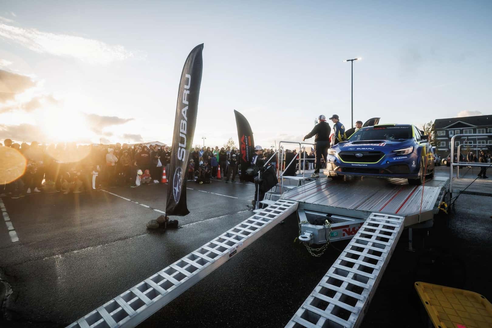 A View Of The ARA National Championship Stage, With The Subaru Motorsports Team And Their Vehicle, And The Crowd Of People Who Attended The Motorsports Competition