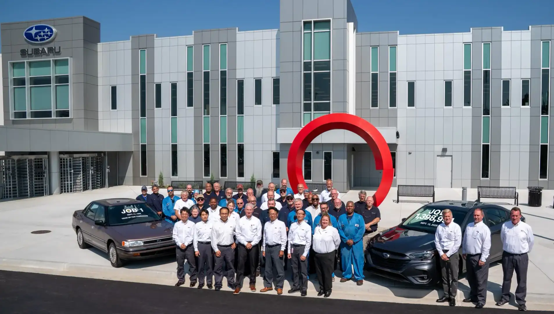 Subaru of Indiana Automotive team in front of headquarters building 