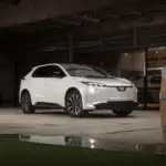 2026 white Subaru Solterra front and side view in rustic garage