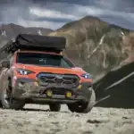 2025 Subaru Crosstrek modified for TransAmerica drive parked off road in front of mountains