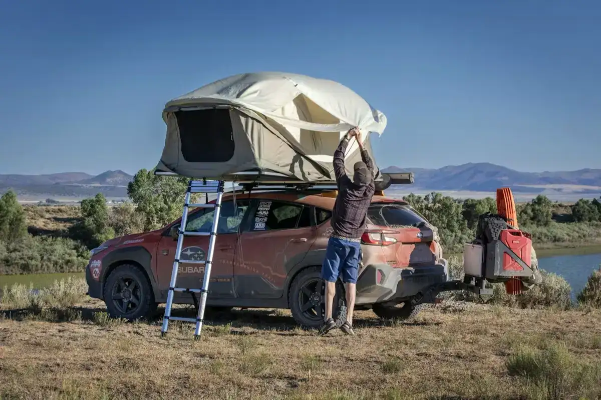2025 Subaru Crosstrek modified for TransAmerica drive parked off road with a car tent on top