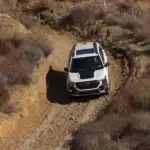 2026 white Subaru Forester Wilderness off roading driving down a dirt road