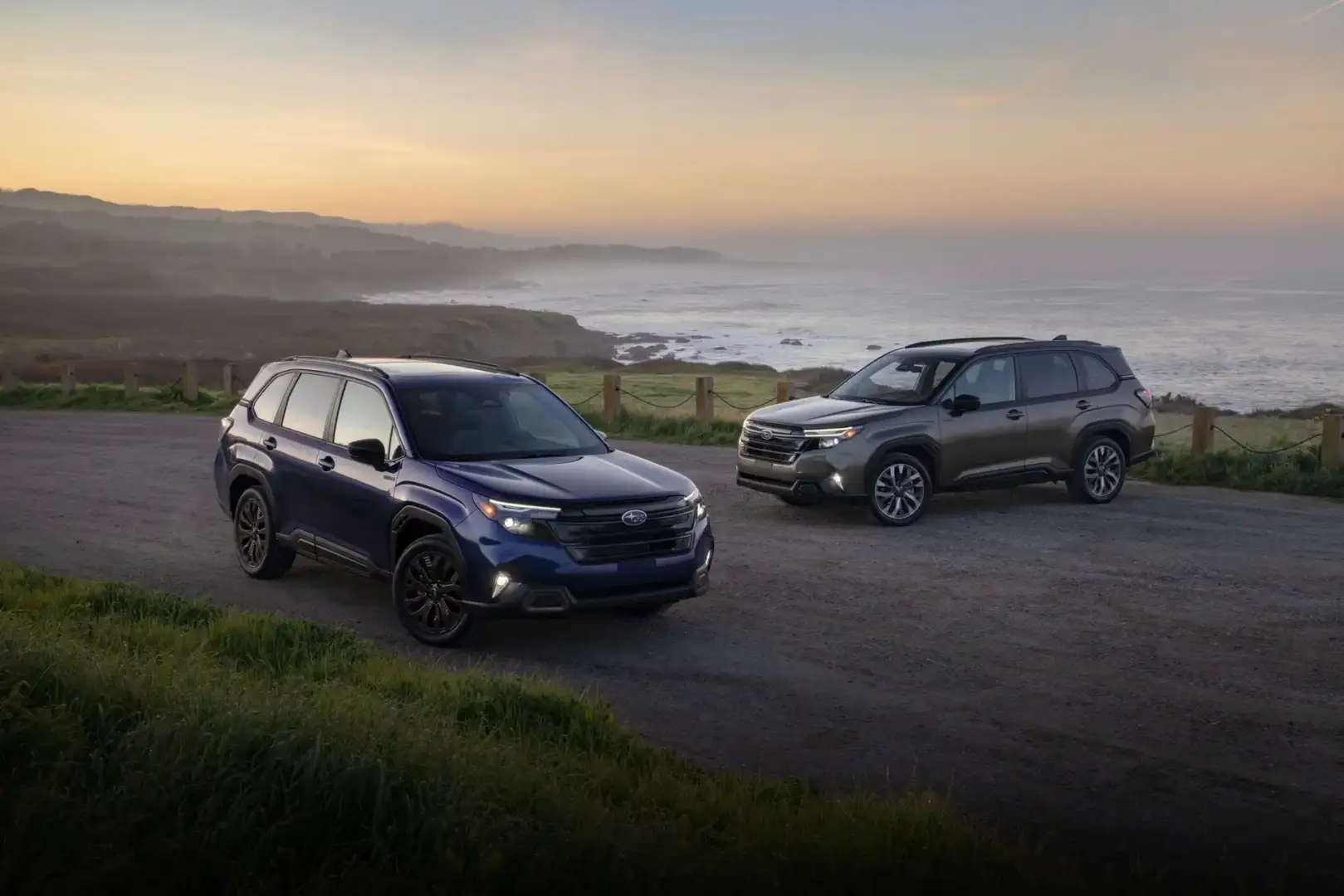 Two Subaru Foresters parked in a lot by a lake