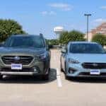 2026 Subaru Outback and 2026 Subaru Impreza parked side by side in a suburban Allen, TX surface lot