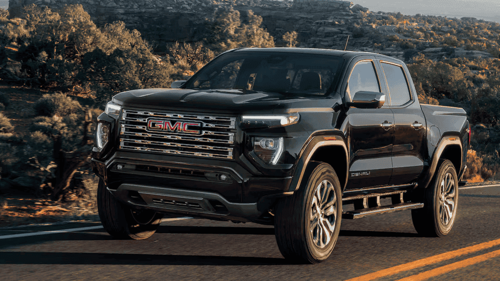 2026 GMC Canyon Denali near Ruth NC in gloss black with chrome GMC grille and Denali badging