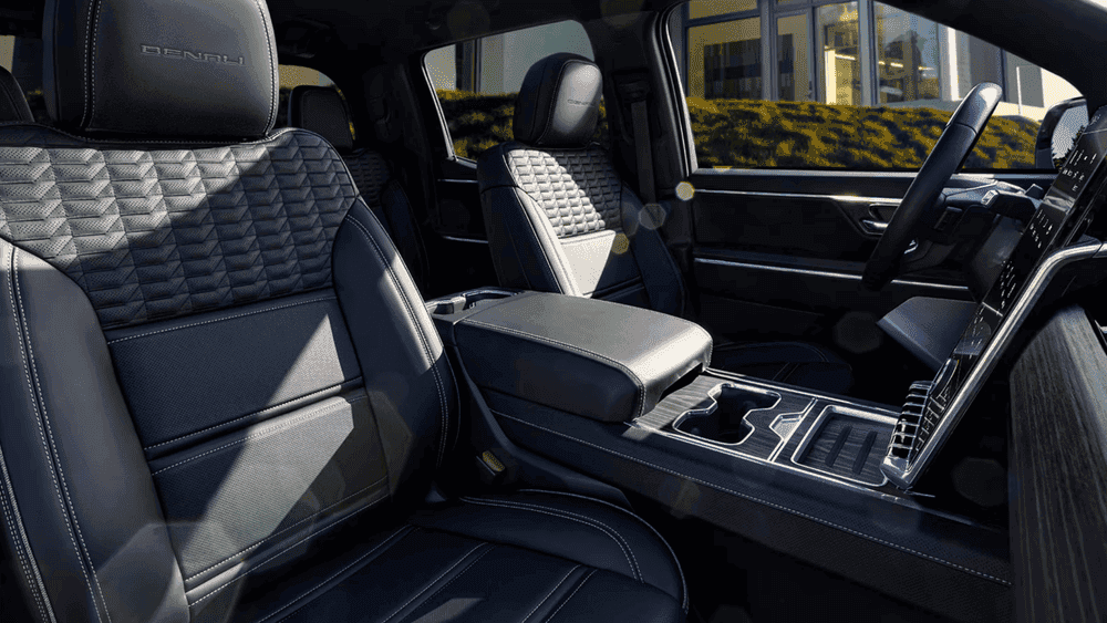 2026 GMC Sierra EV Denali front seats near Ruth NC with quilted black and gray leather and Denali headrest badge