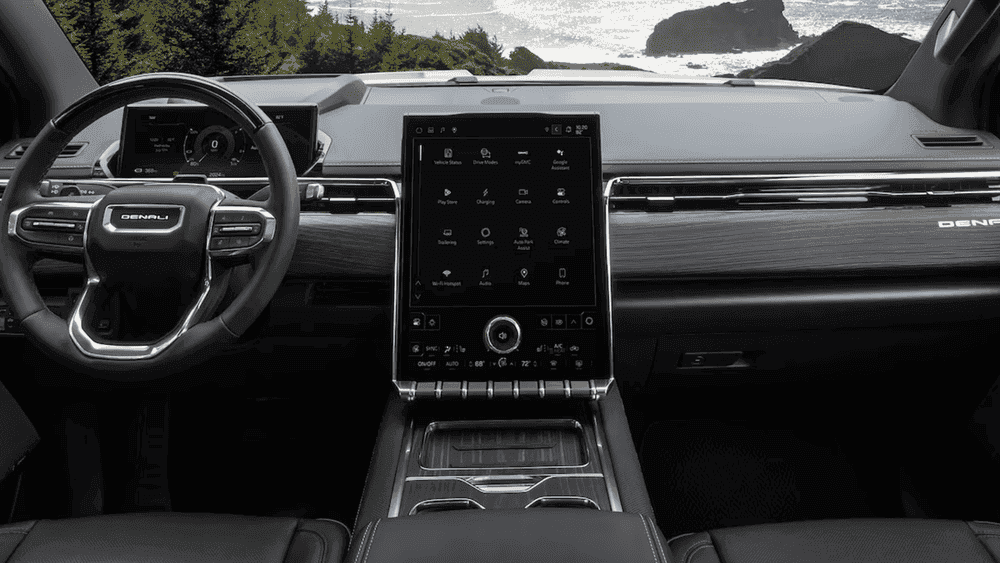 2026 GMC Sierra EV Denali dashboard near Ruth NC with Denali steering wheel and vertical touchscreen showing Charging