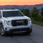 white 2024 GMC Acadia SUV at sunset