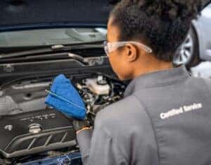Buick Technician changing oil in car