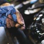 Car service mechanic working on automobile engine repair
