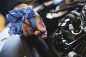 Car service mechanic working on automobile engine repair