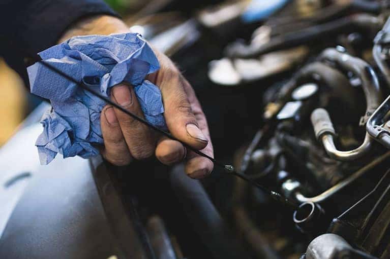 Car service mechanic working on automobile engine repair