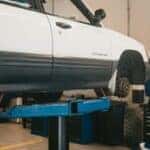 Man in blue working on a car