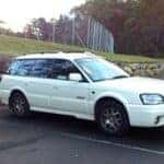 White subaru in a parking space
