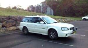 White subaru in a parking space