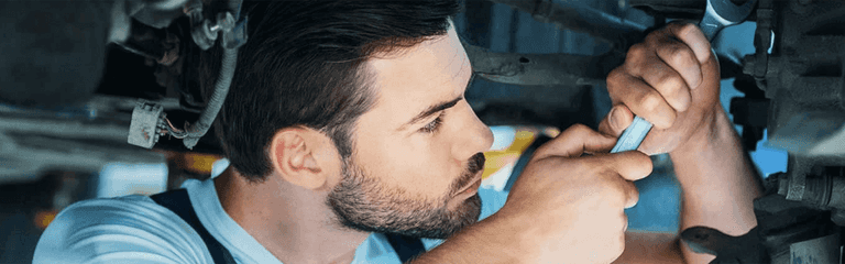 Service Center Certified Technician Working On A Vehicle